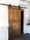 Porta scorrevole per interni stile INDUSTRIAL legno massello scorrimento a carrucole su binario in ferro 95xh220 cm personalizzabile